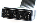 End on view of metal, mis-shaped rectagular data plug with 20 vertical blade pins, housed in plastic case.